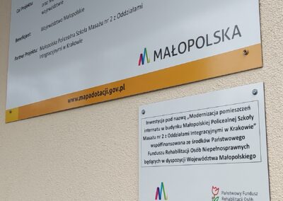 zdjęcie tablic informacyjnych umieszczonych w okolicy wejścia do budynku, dotyczących szczegółów projektu